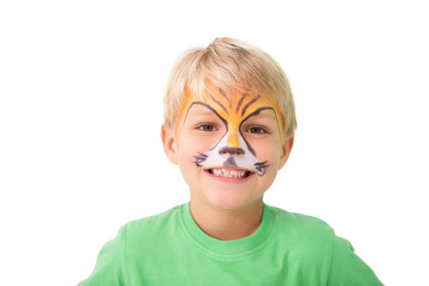 Happy little boy in tiger face paint