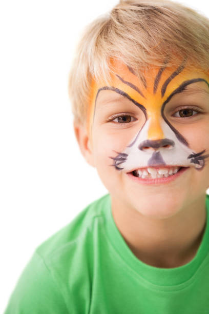 istock Happy little boy in tiger face paint 819464422