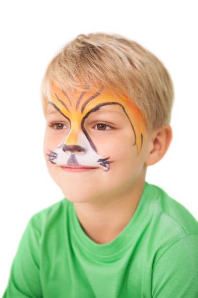 istock Happy little boy in tiger face paint 819464428