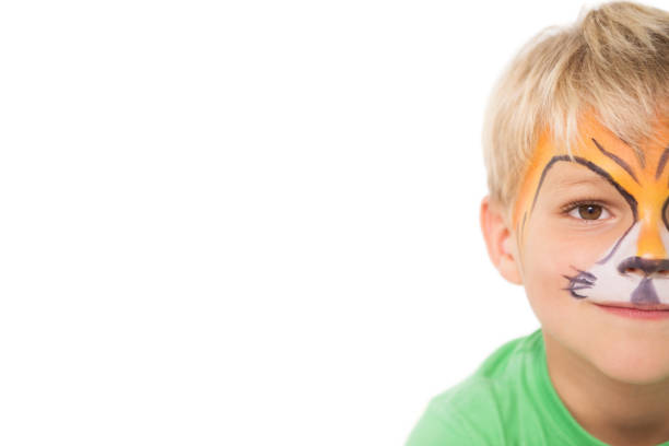 istock Happy little boy in tiger face paint 819464432