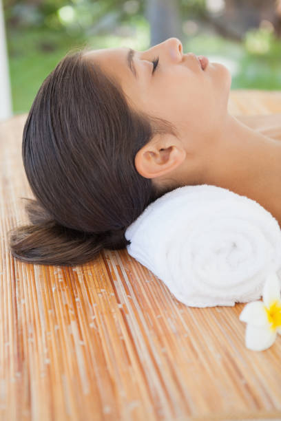 istock Beautiful brunette relaxing on massage table 819464646