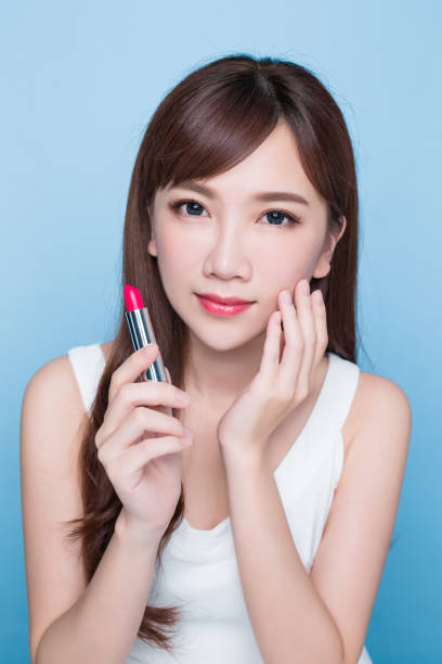 istock beauty woman take lipstick 819467084