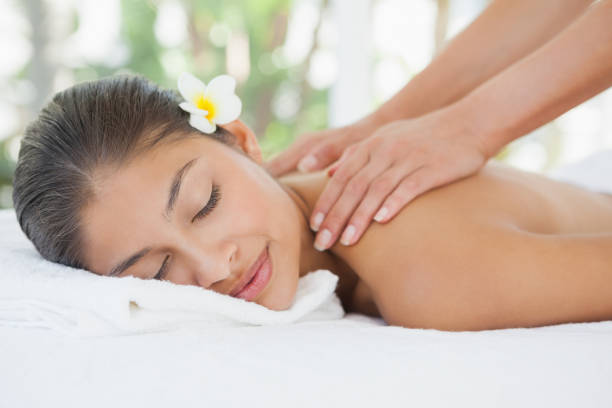 istock Beautiful brunette enjoying a shoulder massage 819474218