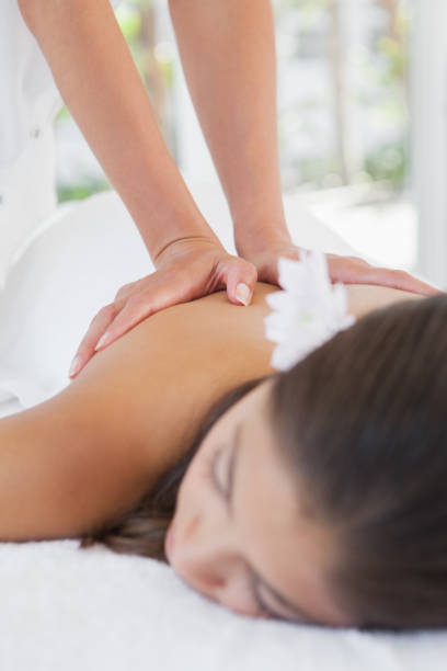 istock Beautiful brunette enjoying a massage 819474364