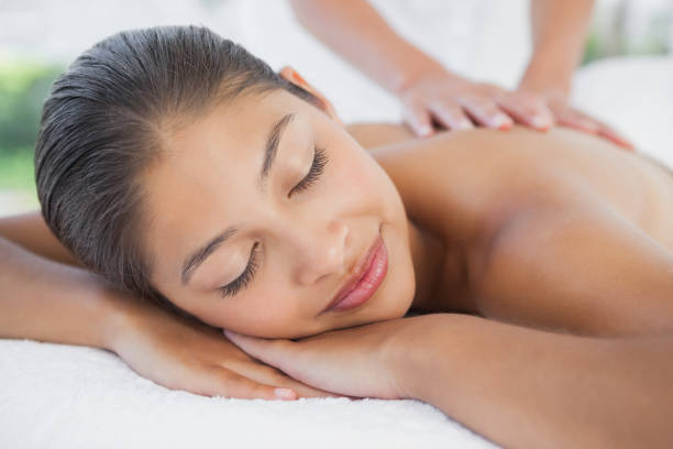 istock Beautiful brunette enjoying a massage 819474392