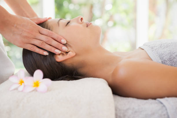 istock Beautiful brunette enjoying a head massage 819476582