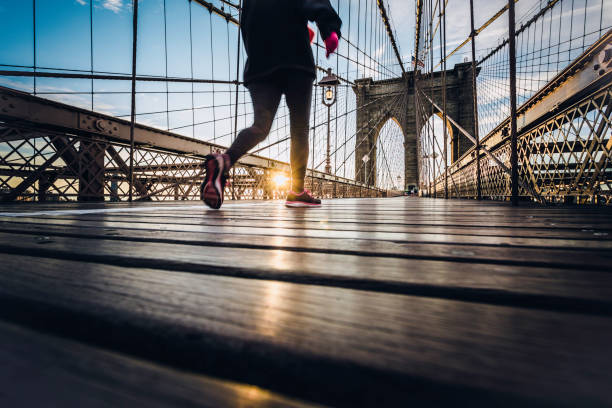 istock Runner on Brooklyn Bridge at Sunrise, New York City 819476726