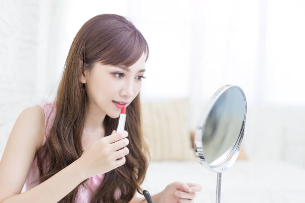 istock beauty woman use lipstick 819476996
