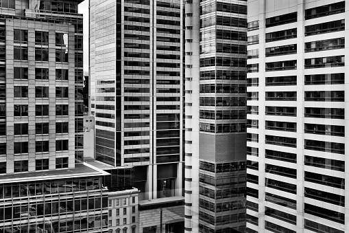 Densly constructed high-rise buildings in Sydney city CBD in black-white. High concentration of business offices and headquarters reflecting busy modern life