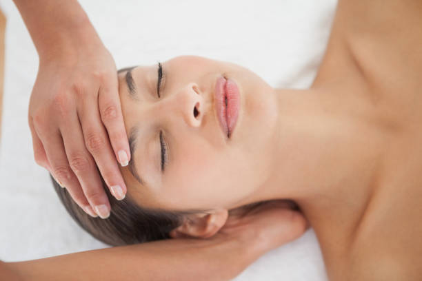 istock Beautiful brunette enjoying a head massage 819488614