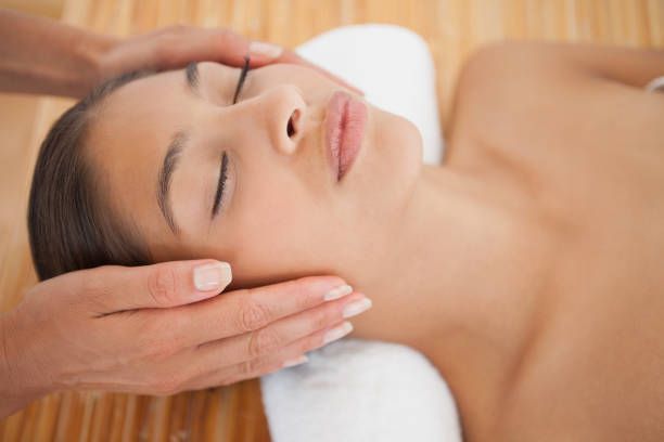 istock Beautiful brunette enjoying a head massage 819488660