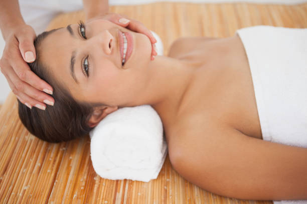 istock Beautiful brunette enjoying a head massage 819488674