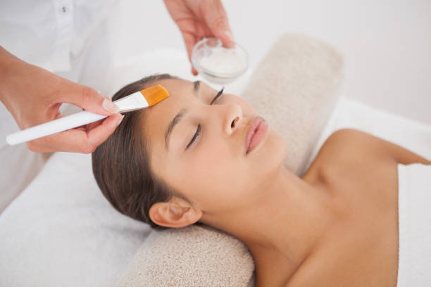 istock Beautiful brunette getting a facial 819488698