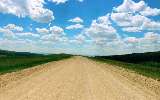 istock Dirt road under beautiful summer sky 819504094