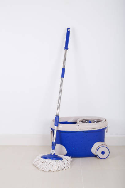 istock mop and blue bucket on floor and wall background 819507122