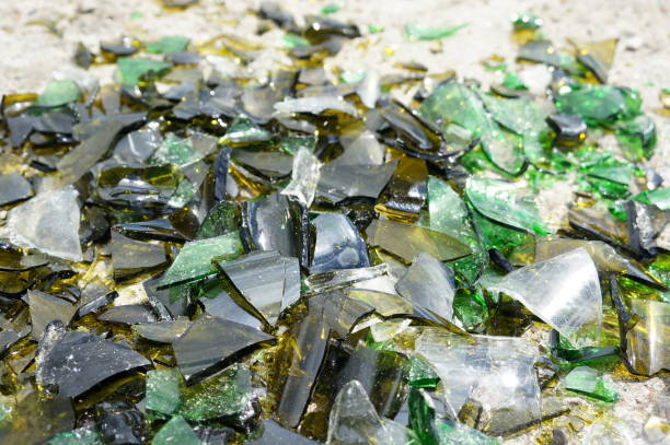 istock Fragments of colored broken glass on a concrete surface 819521798
