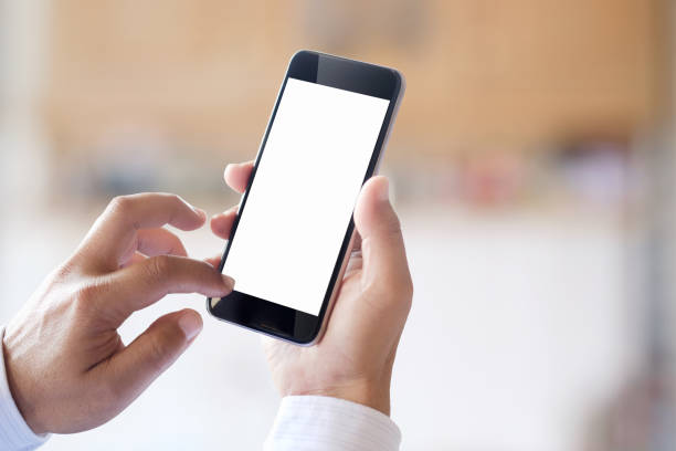 istock Mock up Smartphone : Business man hands holding mobile phone with abstract bokeh background. 819534864