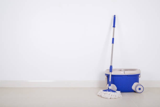 istock mop and blue bucket on floor and wall background 819535118