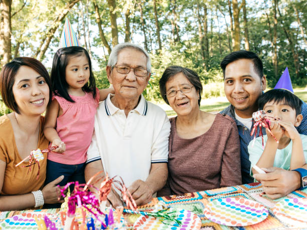 istock Three generation family celebrating birthday with cake 819535172
