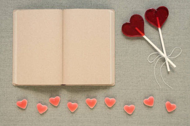 istock Heart-shaped lollipops, candies and an old diary 819535648