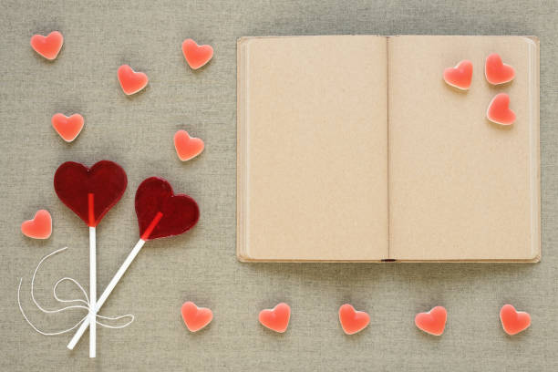 istock Heart-shaped lollipops, candies and an old diary 819537744