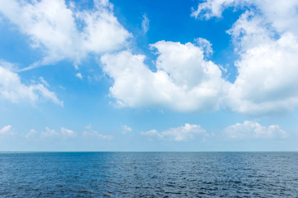 istock White cloud on the blue sky with sea background 819540302