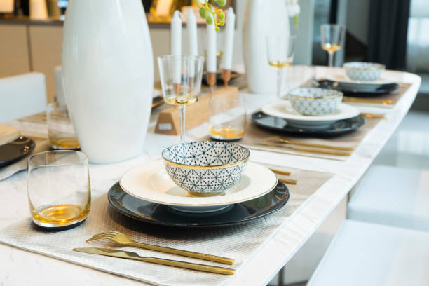 Dining Table with Plate Settings. Beautiful Luxury Dining Table with Plate Settings at Home dealing room photos stock pictures, royalty-free photos & images