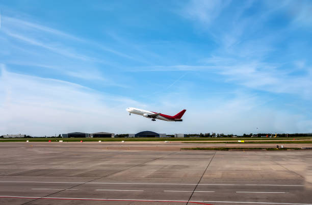 The plane going to take off on the runway on the background of blue sky with Cirrus clouds. stock photo