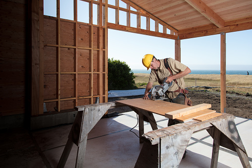 Carpenter building a home at construction site