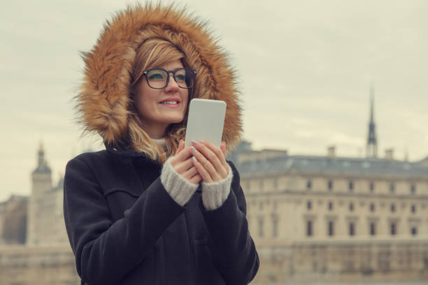 Cute girl using cellphone in Paris, France. Cute girl using cellphone in Paris, France. german free democratic party photos stock pictures, royalty-free photos & images
