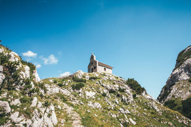 Old stone chapel on top of the mountain (Kamnik-Savinja Alps, Slovenia - Molicka plateau).