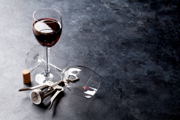 istock Red wine glasses and corkscrew 819562348