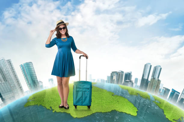 istock Young asian tourist with suitcase wearing hat standing 819569008