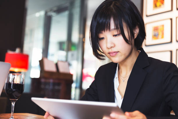 istock Female business executive working on her digital tablet 819574370