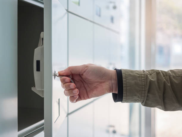 Hand with Key Open Locker in Locker room stock photo