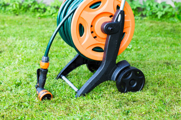 istock Coiled garden hose on reel, grass backgound 819581834