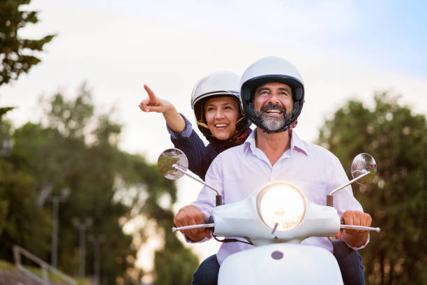 istock Happy Mature Couple Driving Scooter 819582104