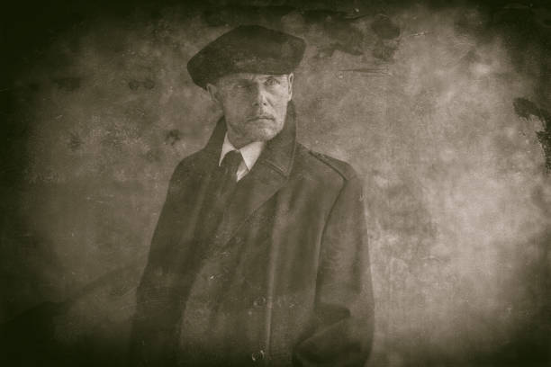 istock Retro 1920s english gangster wearing flat cap and coat. 819584576