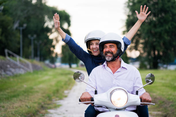 istock Happy Mature Couple Driving Scooter 819584640