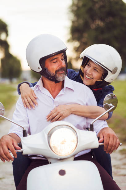 istock Happy Mature Couple Driving Scooter 819585008