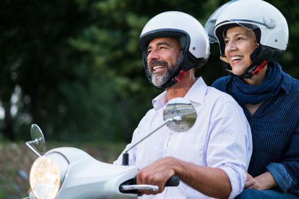 istock Happy Mature Couple Driving Scooter 819585034