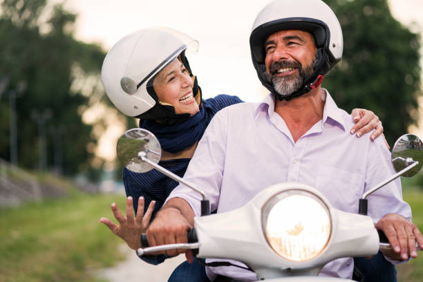 istock Happy Mature Couple Driving Scooter 819585372