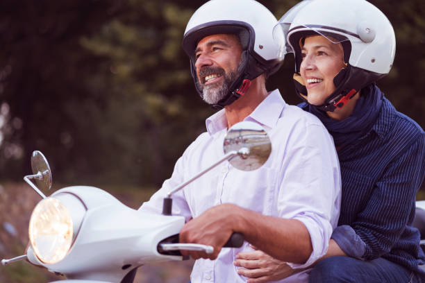 istock Happy Mature Couple Driving Scooter 819585374