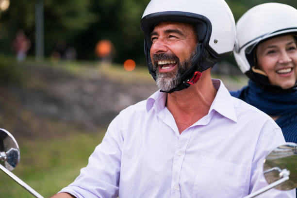 istock Happy Mature Couple Driving Scooter 819585460