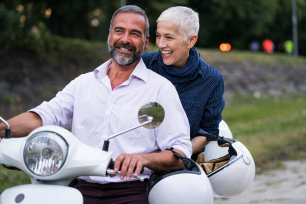 istock Happy Mature Couple Driving Scooter 819587558