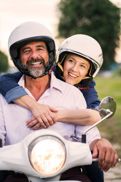 istock Happy Mature Couple Driving Scooter 819587560