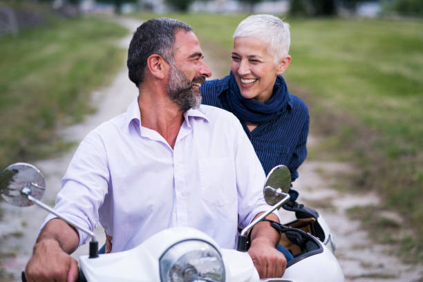 istock Happy Mature Couple Driving Scooter 819587668