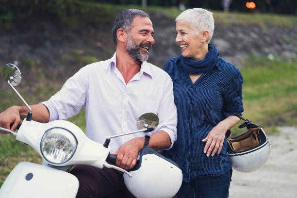 istock Happy Mature Couple Driving Scooter 819587996