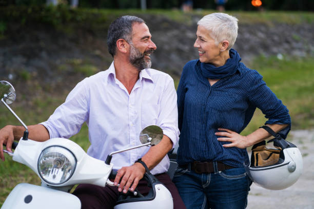 istock Happy Mature Couple Driving Scooter 819588162