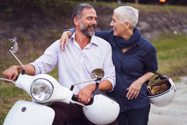 istock Happy Mature Couple Driving Scooter 819588166